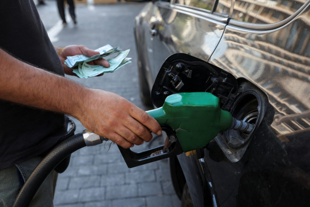 A worker fills up a car with fuel at a gas station in Beirut