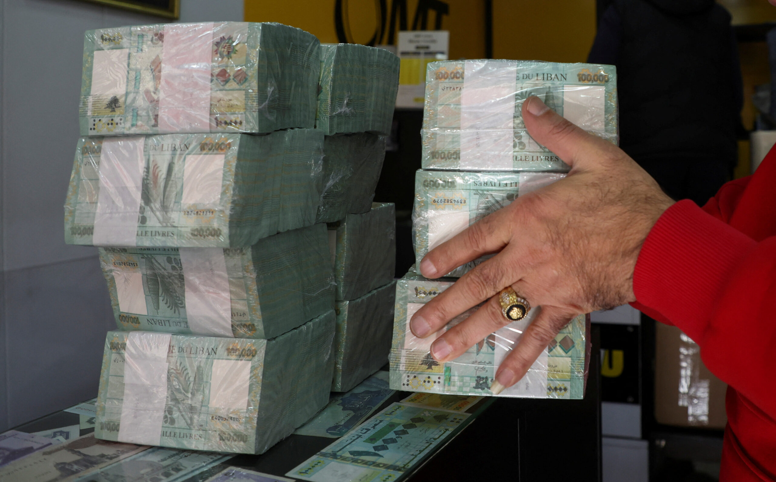FILE PHOTO: A money exchange vendor holds Lebanese pound banknotes at a shop in Beirut
